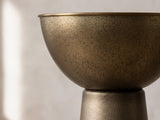 Close-up of the Melpignano Antique Gold Iron Pedestal Side Table: the half-sphere bowl resting on the tapered cone