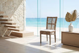 Mendicino Tall-Back Rattan and Mahogany Dining Chair in an oceanfront glass house