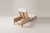 The Menfi lounger from behind: the slatted acacia backrest raised on its prop between the two wicker armrests
