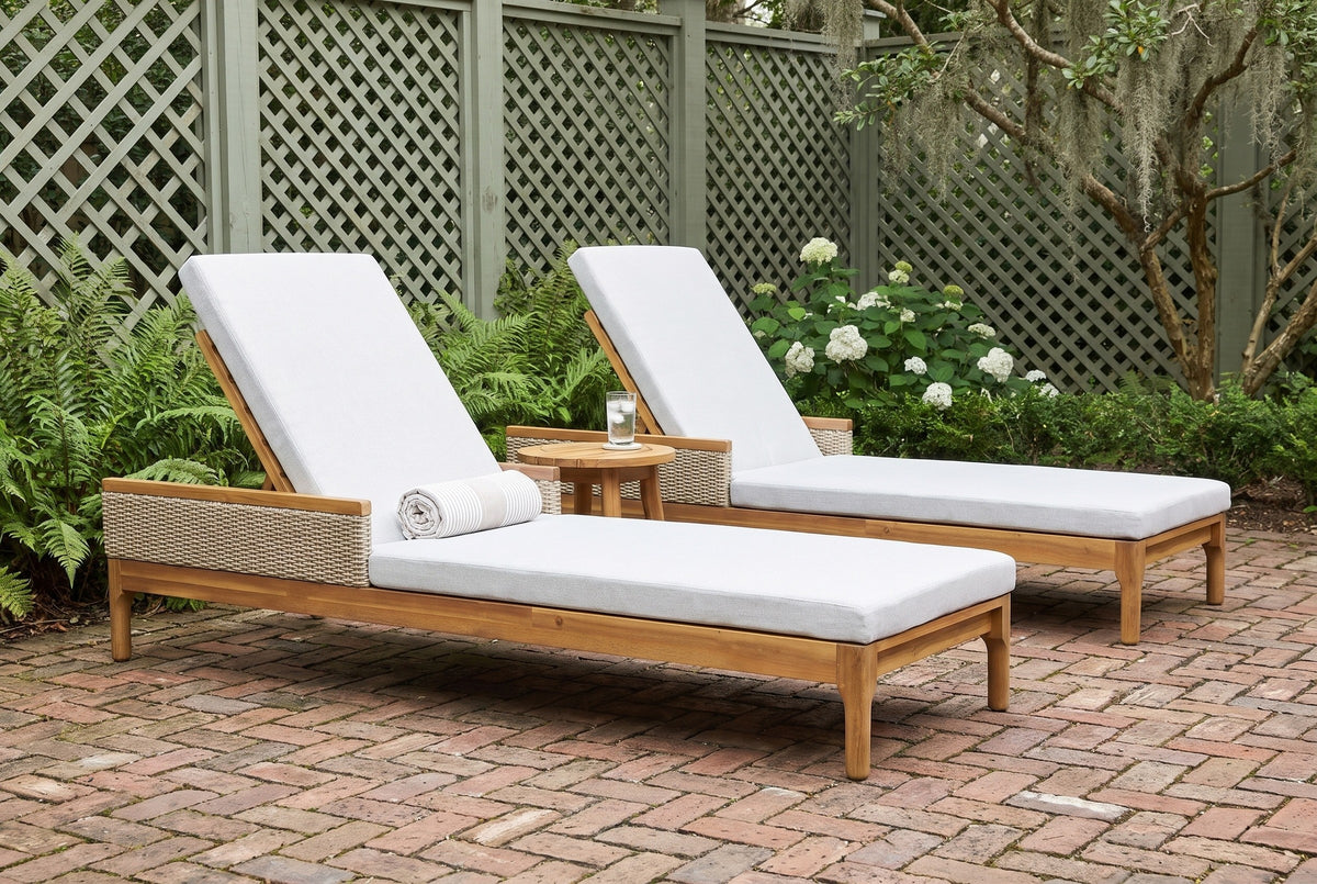 The two Menfi acacia chaise loungers in a Savannah walled garden with a sage-green lattice screen and herringbone brick pavers (side table and towel not included)