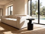 Mesoraca Black Mango Pedestal Side Table beside a linen sofa in a poolside villa