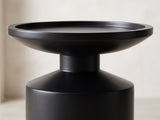 Close-up of the Mesoraca Black Mango Pedestal Side Table: the raised rim of the tray top over the neck and the sloped shoulder