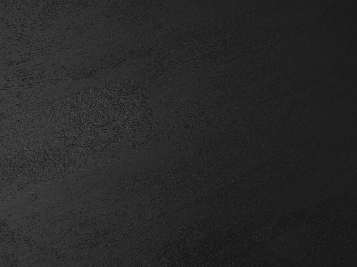 Close-up of the Miglionico Black Mango Wood Faceted Drum Side Table: the black-stained mango grain of the top