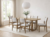 Mileto 72-Inch Light Oak Trestle Dining Set with 6 Upholstered Chairs in a bright plaster dining room with linen curtains