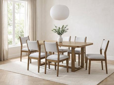 Mileto 72-Inch Light Oak Trestle Dining Set with 6 Upholstered Chairs in a bright plaster dining room with linen curtains