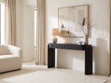 Minervino Black Oak Fluted Racetrack Console Table against a plaster wall under an abstract canvas in a bright living room