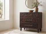 Mirano 33-Inch Velvet Mocha Carved Mango 3-Drawer Chest under a round bronze mirror in a villa bedroom