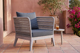 Mistretta rope lounge chair on a terracotta-tiled terrace in Ojai, a pink lime-plaster wall, an olive tree and bougainvillea behind (side table not included)