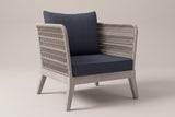 The Mistretta rope lounge chair with slate grey cushions, three-quarter front view on a light studio backdrop