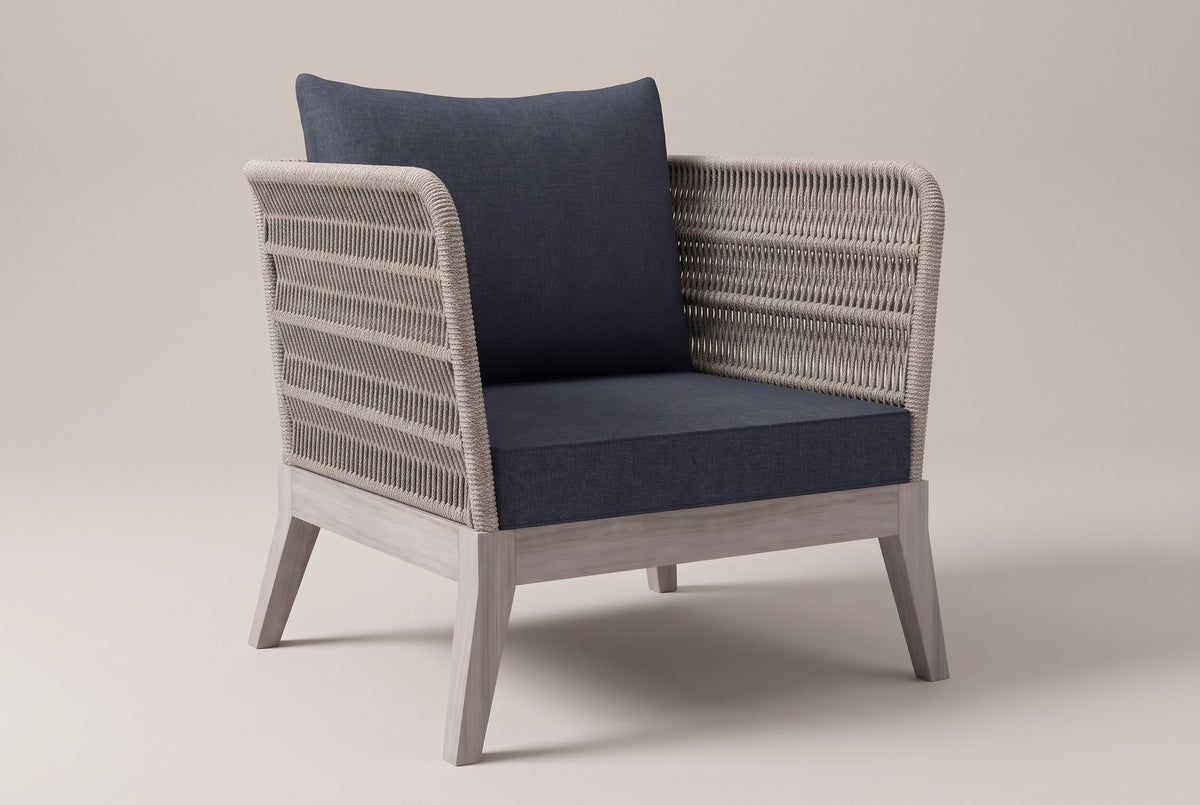 The Mistretta rope lounge chair with slate grey cushions, three-quarter front view on a light studio backdrop