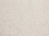 Close-up of the Modica Cream Fiberglass Pebble Coffee Table: the flecked matte cream finish of the fiberglass