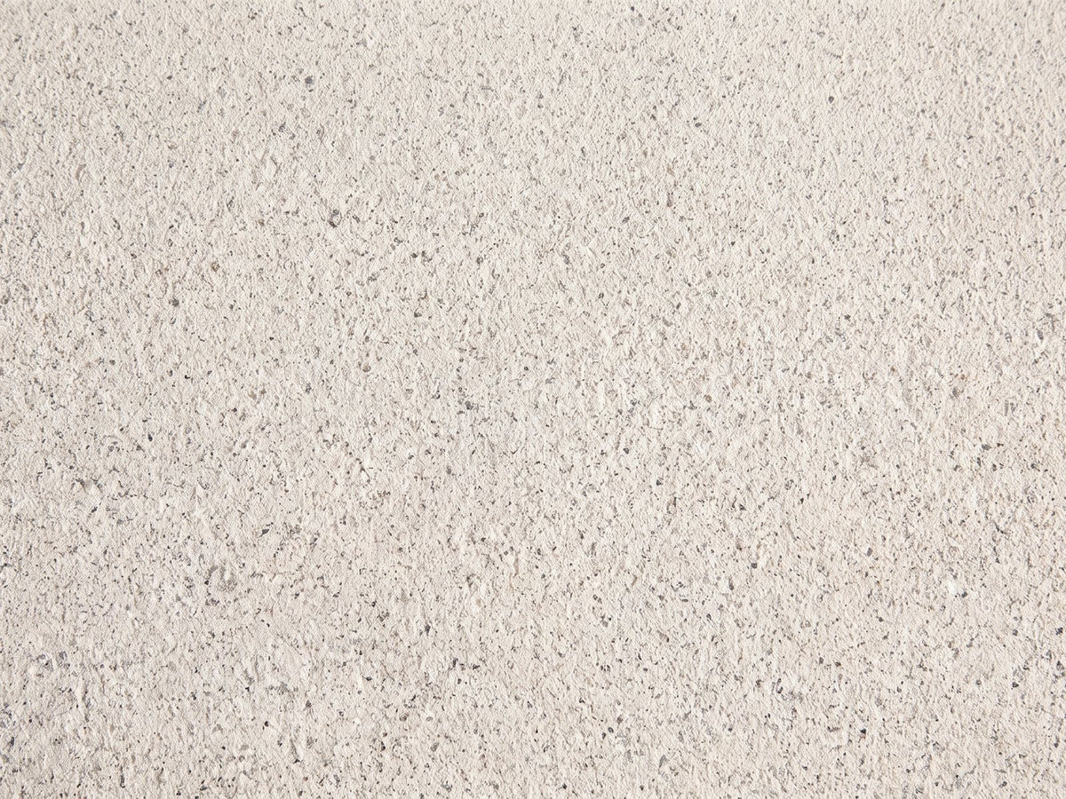 Close-up of the Modica Cream Fiberglass Pebble Coffee Table: the flecked matte cream finish of the fiberglass