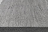 Close-up of the sandblasted grey mango wood on the Molfetta cabinet: long grain lines with a rough, open texture running to a square edge
