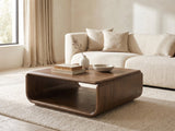 Molveno Walnut-Tone Wood Veneer Coffee Table styled with books, a vase and a stone bowl in front of a cream sofa in a bright plaster room
