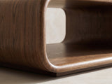 Close-up of the Molveno Walnut-Tone Wood Veneer Coffee Table: the curved bend where the side wall meets the open shelf