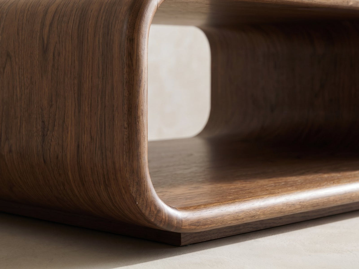 Close-up of the Molveno Walnut-Tone Wood Veneer Coffee Table: the curved bend where the side wall meets the open shelf
