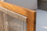 Close-up of the Mondello club chair: the honey acacia top rail and square post above the woven rope on the side frame