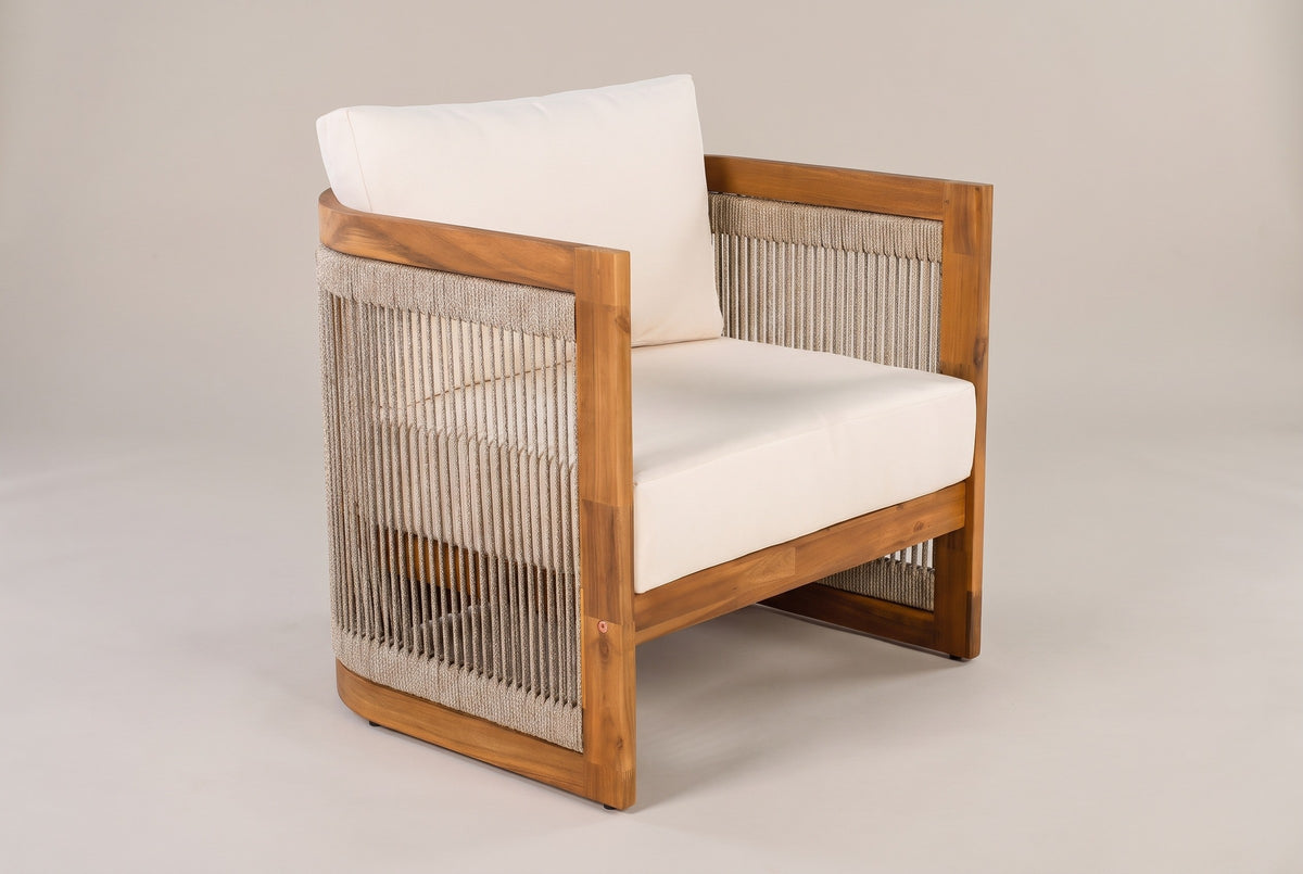 The Mondello acacia club chair with ivory cushions, three-quarter view from the front on a light studio backdrop