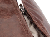 Close-up of the Moneglia Distressed Brown Top-Grain Buffalo Leather Round Pouf: zip
