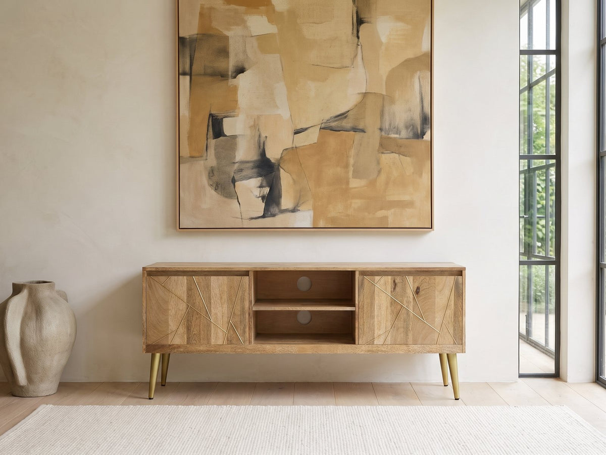 Monopoli Mango and Brass Media Console under a large abstract painting in a bright living room