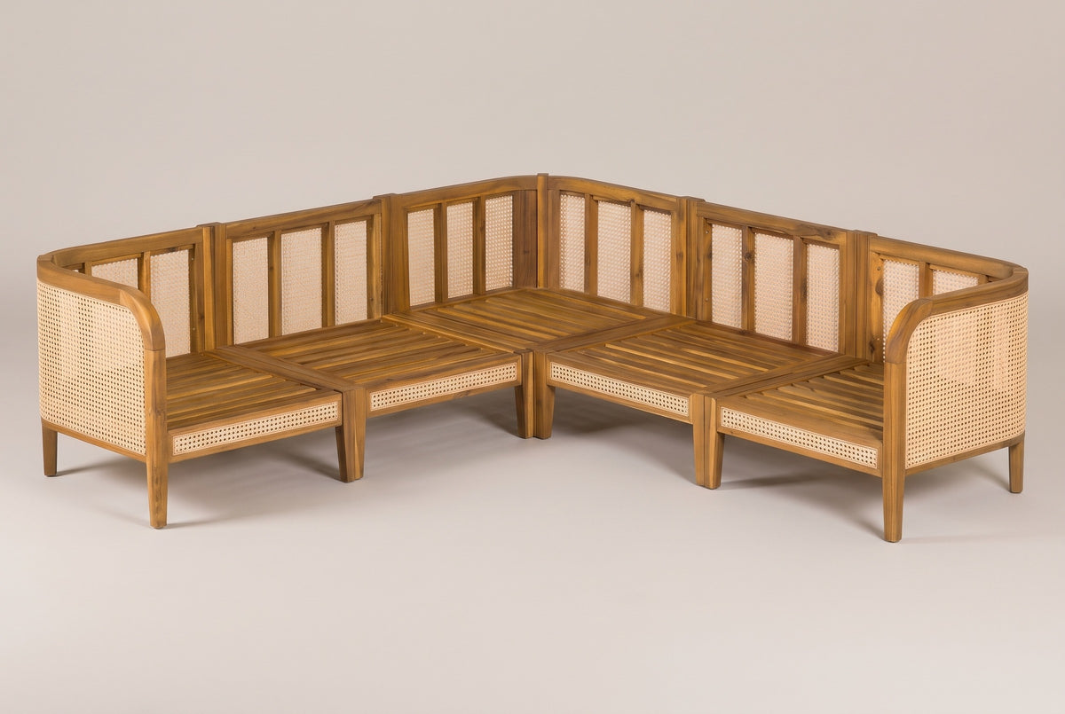 The five acacia frames of the Monreale sectional without cushions, pushed together into a V, with slatted seat decks and cane back panels