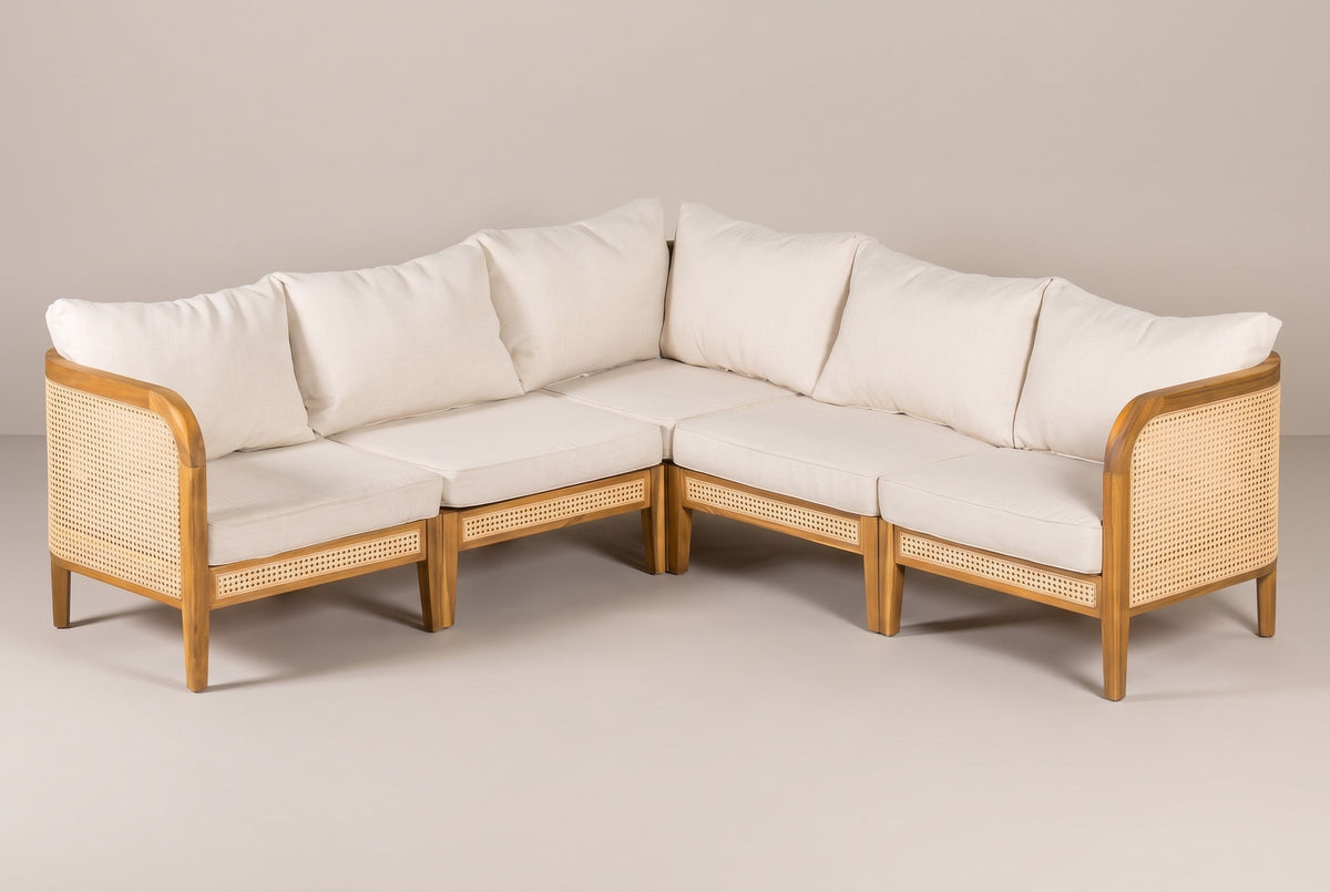 The Monreale five-seat acacia and cane corner sectional with cream cushions, seen into the corner on a light studio backdrop