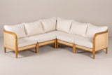 The Monreale five-seat acacia and cane corner sectional with cream cushions, seen into the corner on a light studio backdrop
