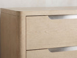 Close-up of the Monselice 38-Inch Light Elm 5-Drawer Chest: the recessed brushed-nickel finger-pull slot at the top of a drawer