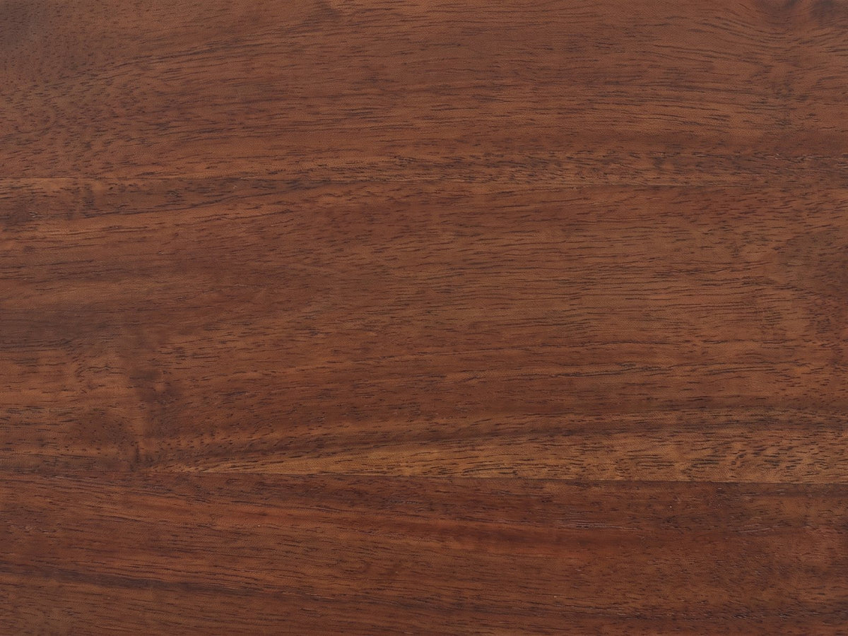 Close-up of the Montalbano Carved Mango Pedestal Side Table: the dark mango grain of the round top