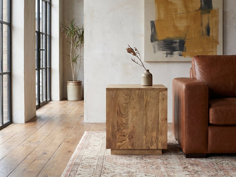 Montecatini Square Mango Side Table beside a leather sofa in an industrial loft