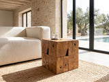 Montefiore Teak Root Cube Side Table beside a linen sofa in a poolside villa