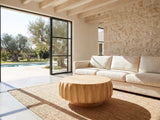Montepulciano Fluted Ash Coffee Table on a jute rug in front of a linen sofa in a poolside villa