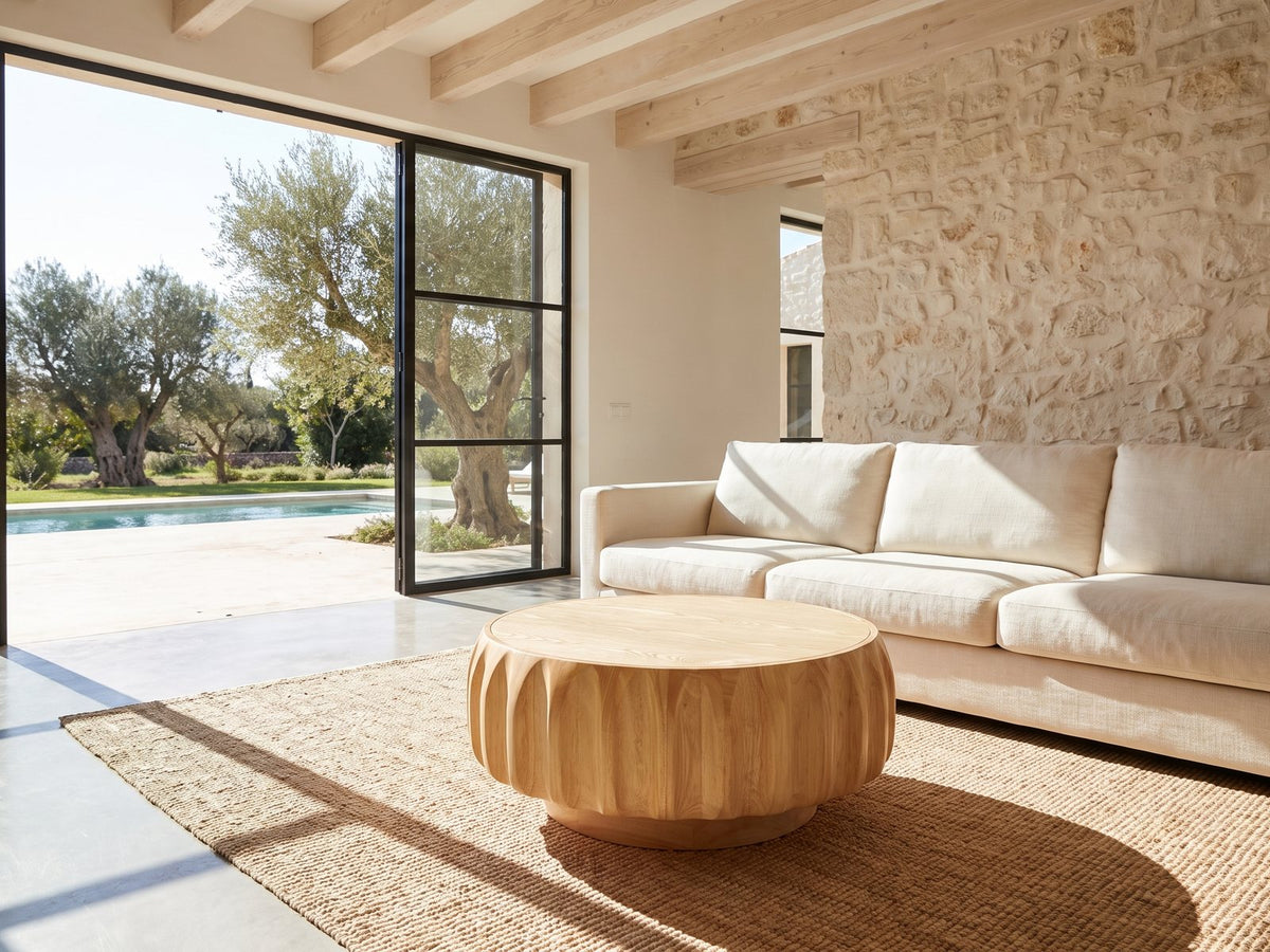 Montepulciano Fluted Ash Coffee Table on a jute rug in front of a linen sofa in a poolside villa