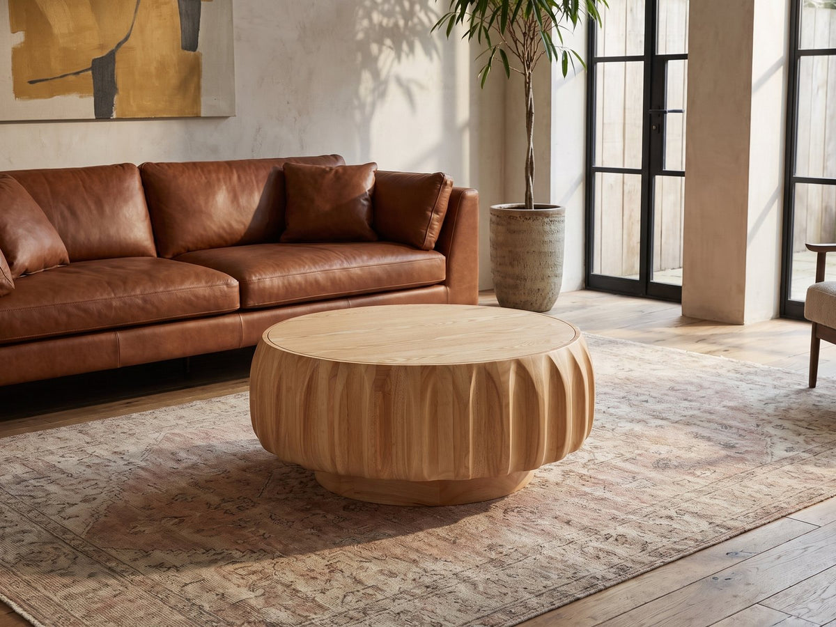 Montepulciano Fluted Ash Coffee Table on a vintage rug in front of a leather sofa in an industrial loft