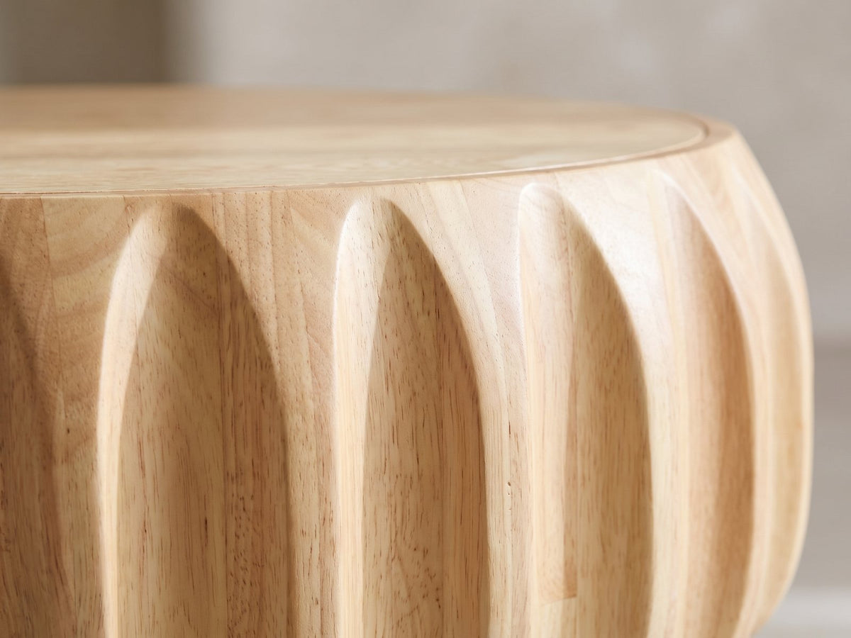 Close-up of the Montepulciano Fluted Ash Coffee Table: the carved vertical flutes of the drum under the top