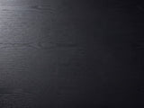 Close-up of the Monterosso Black Wood Veneer Fluted Oval Coffee Table: the open grain of the matte black top