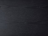 Close-up of the Monterosso Black Wood Veneer Fluted Oval Console Table: the open grain of the black top