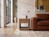 Monticchiello Driftwood Oak Veneer Cube Side Table beside a leather sofa in an industrial loft