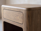 Close-up of the Monticchiello Driftwood Oak Veneer Cube Side Table: the rounded top edge, the push-open drawer and the open niche