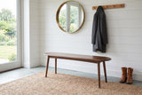 Montone bench on a jute rug against a white shiplap wall in a Portland sunroom entry with a slate floor, a round mirror and boots
