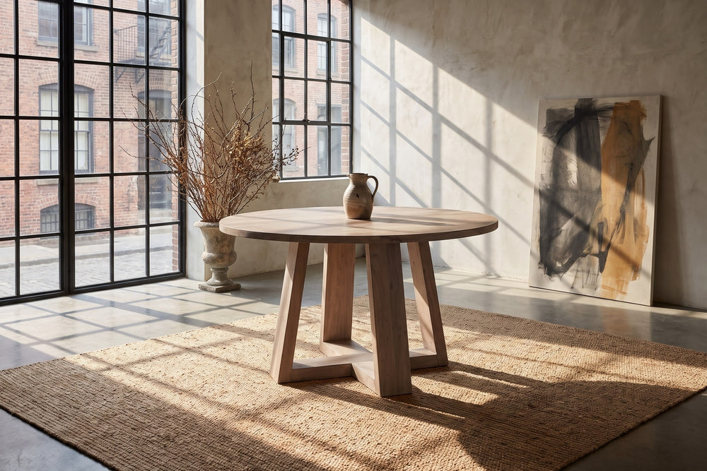 Morano 54-Inch Round Grey-Washed Solid Acacia Dining Table in a city loft