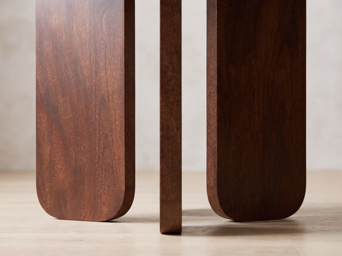 Close-up of the Morciano Mango Wood Round Side Table: the rounded feet of the three mango slab legs