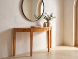 Mottola Mappa Burl Half-Moon Console Table under a round mirror in a travertine entryway