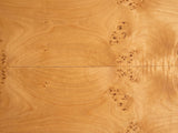 Close-up of the Mottola Mappa Burl Half-Moon Console Table: the honey-gold mappa burl veneer of the top