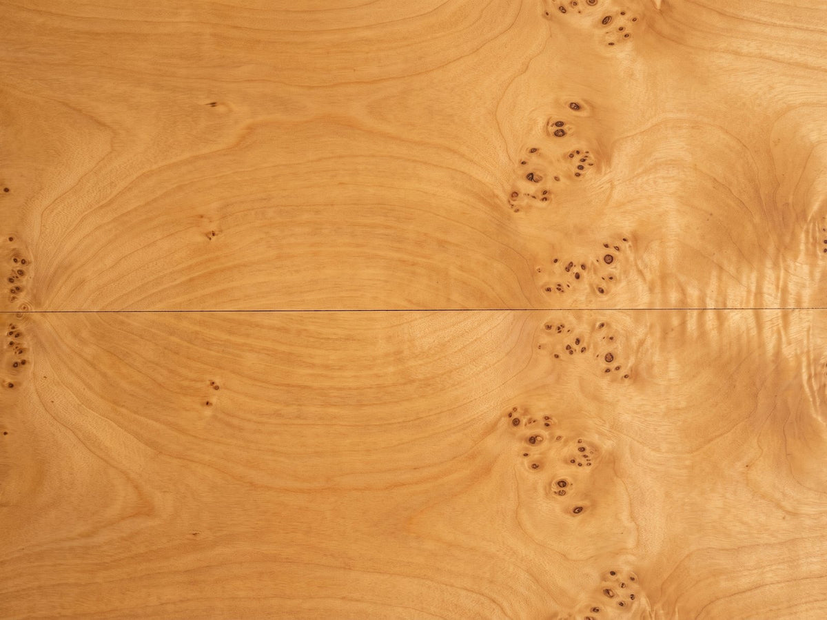 Close-up of the Mottola Mappa Burl Half-Moon Console Table: the honey-gold mappa burl veneer of the top