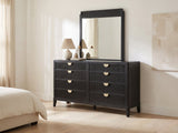 Murano 66-Inch Black Oak 8-Drawer Dresser with Mirror against a plaster wall under an abstract canvas in a bright bedroom