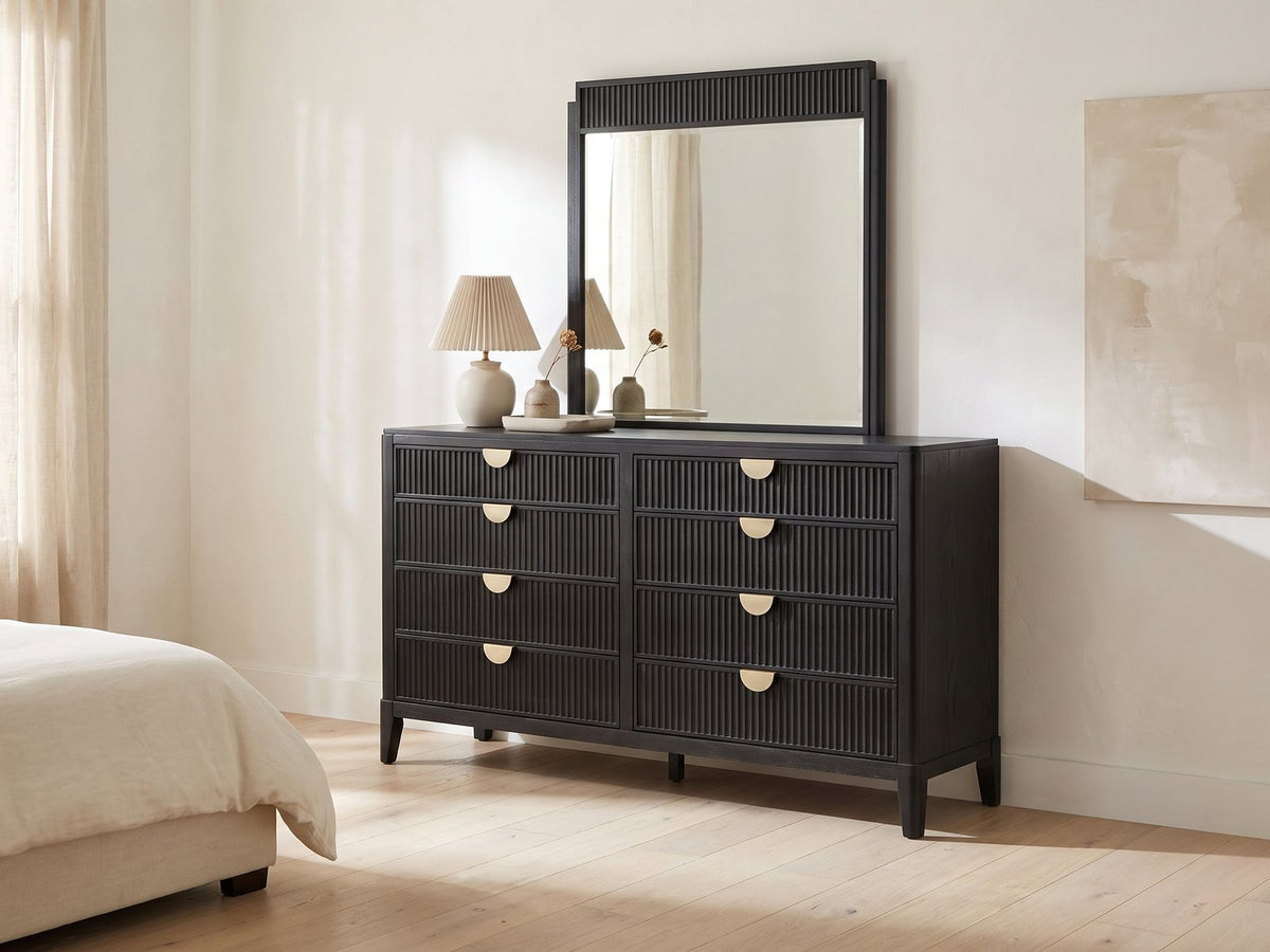Murano 66-Inch Black Oak 8-Drawer Dresser with Mirror against a plaster wall under an abstract canvas in a bright bedroom