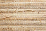Close-up of the natural grasscloth on the Muravera nightstand: blades of grass in sand, oatmeal and light honey held by fine cotton threads