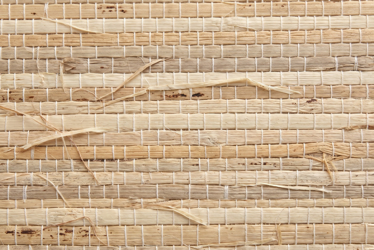 Close-up of the natural grasscloth on the Muravera nightstand: blades of grass in sand, oatmeal and light honey held by fine cotton threads