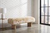 Narni sheepskin bench along a white-painted brick wall in a Chicago loft with a tall steel-framed window and a polished concrete floor (side table and lamp not included)